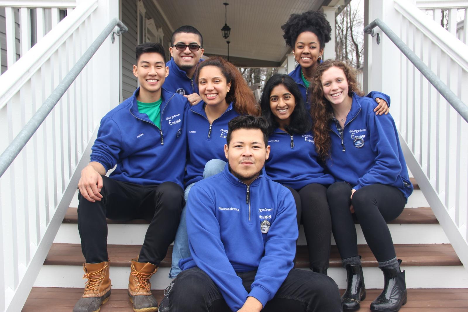 ESCAPE leaders smiling while sitting on the steps of the Calcagnini Contemplative Center