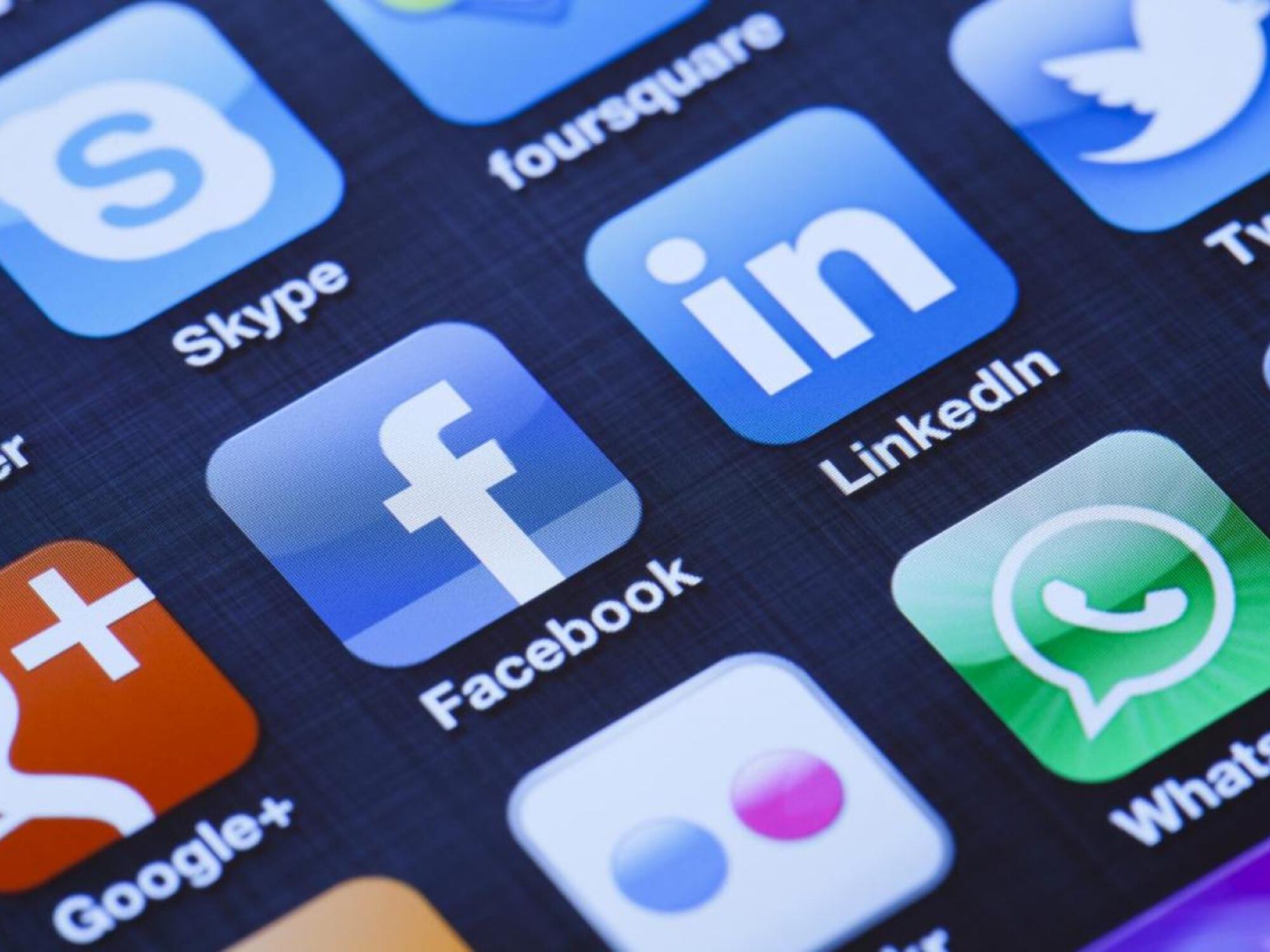 Image of Cellphone with icons of social media facebook, instagram, twitter, google application on screen