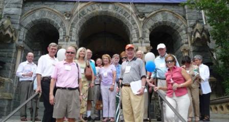 alumni posing in front of healy hall