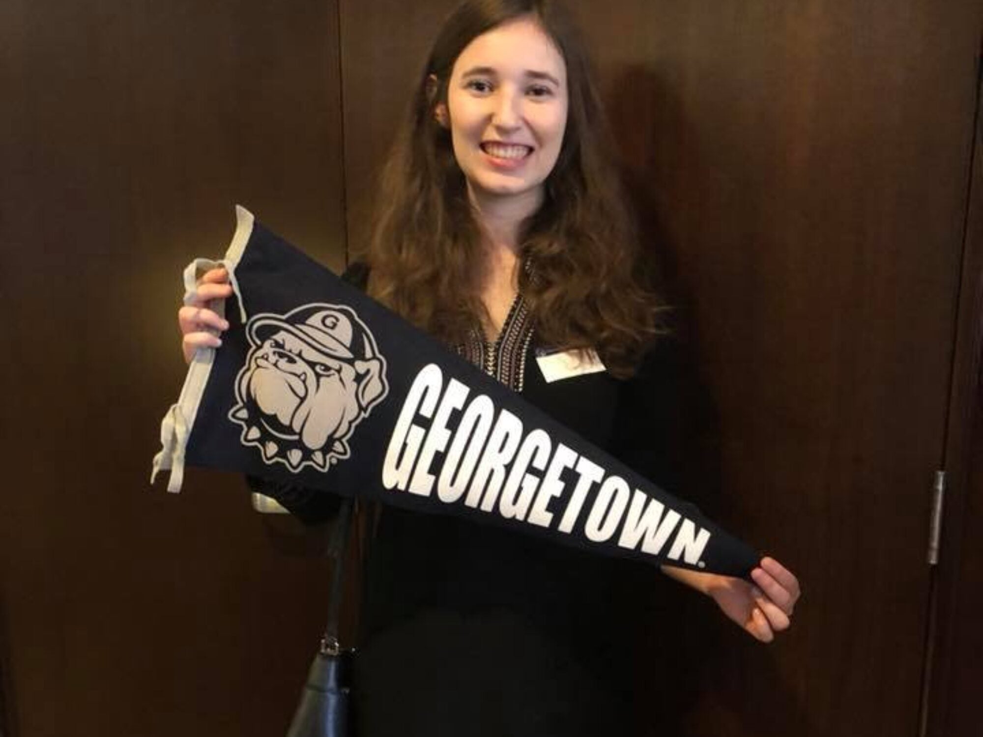 alumni holding georgetown flag