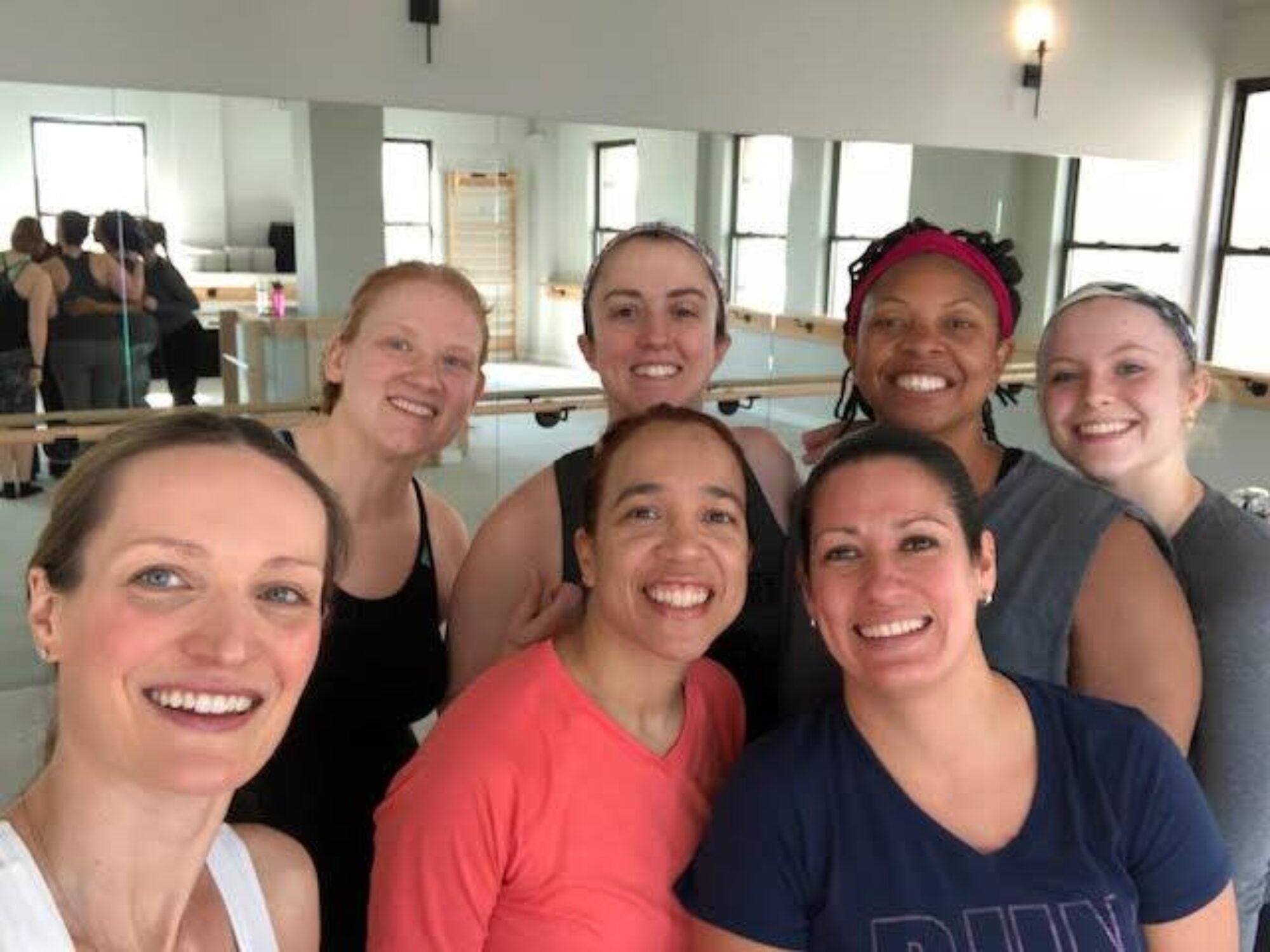 alumni posing together at workout class