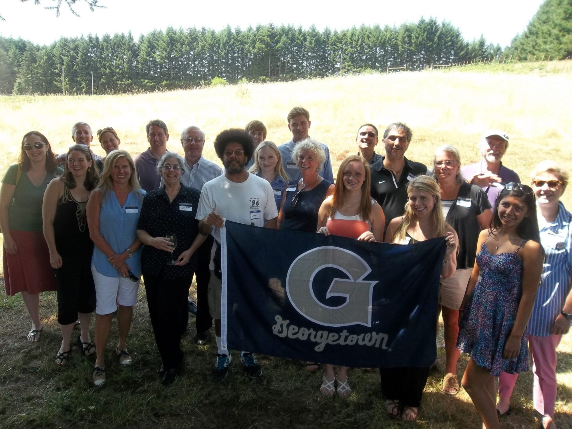 club of oregon alumni posing holding banner