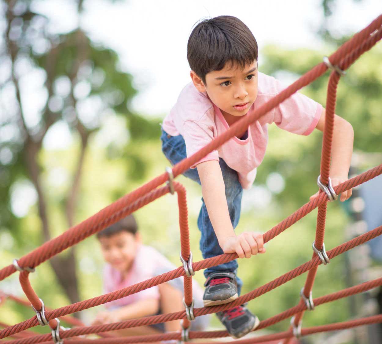 kid climbing on jungle gym
