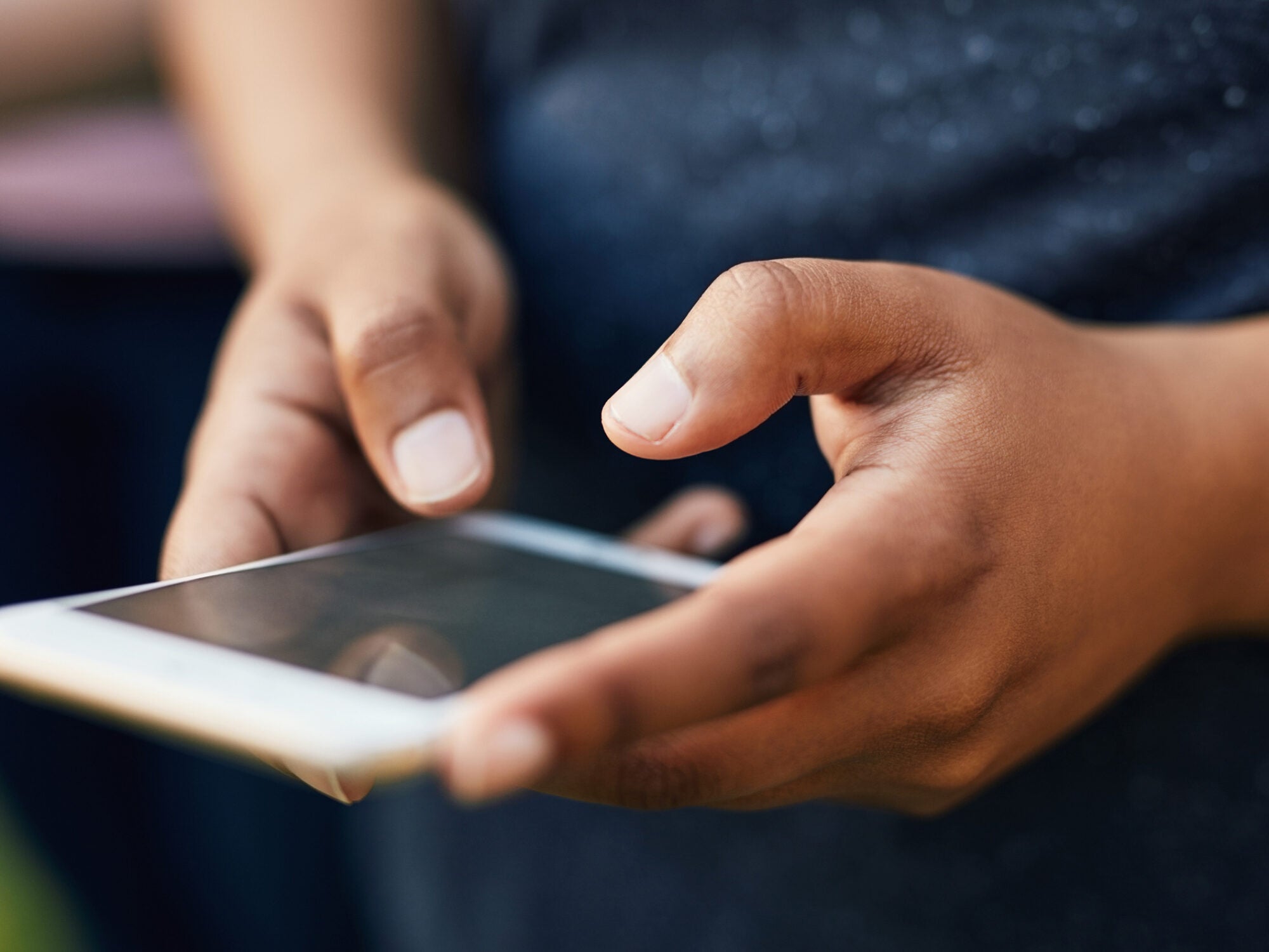 Cropped shot of an unrecognizable woman using her cellphone outdoors