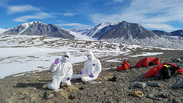 researchers in hazmat suits at the McMurdo Station