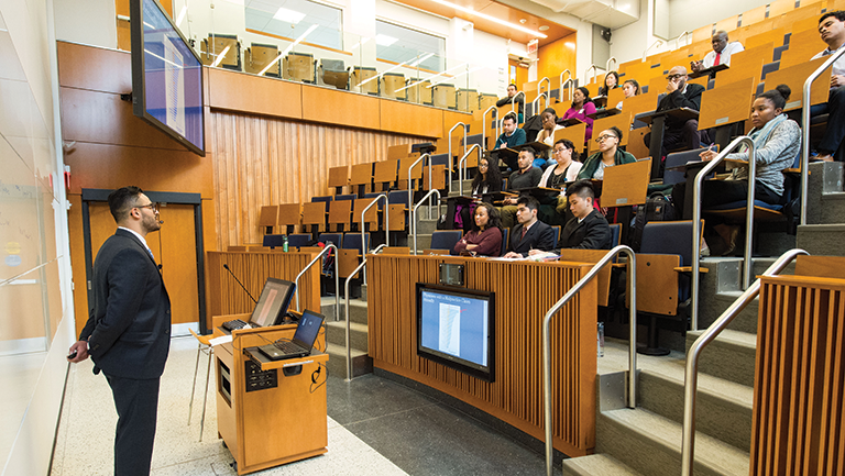 students sitting in lecture hall with professor