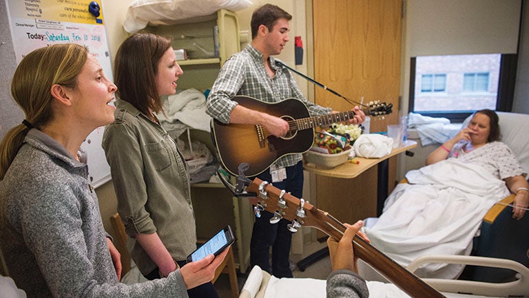medical students singing for patient