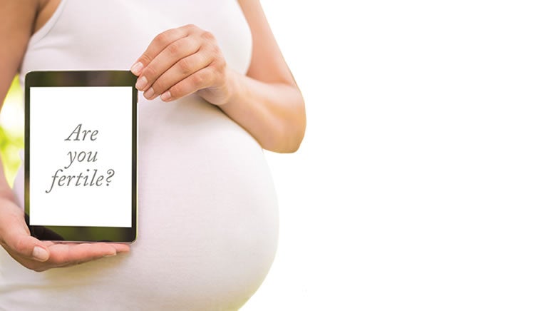 pregnant person holding ipad with words on it that say: are you pregnant?