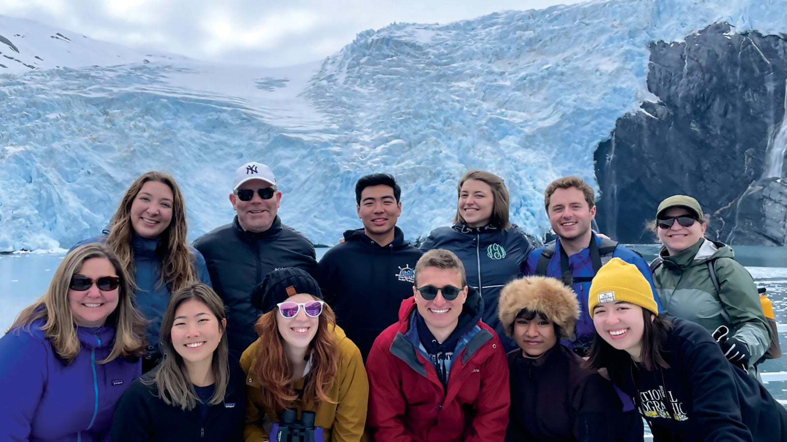 students posing by glacier