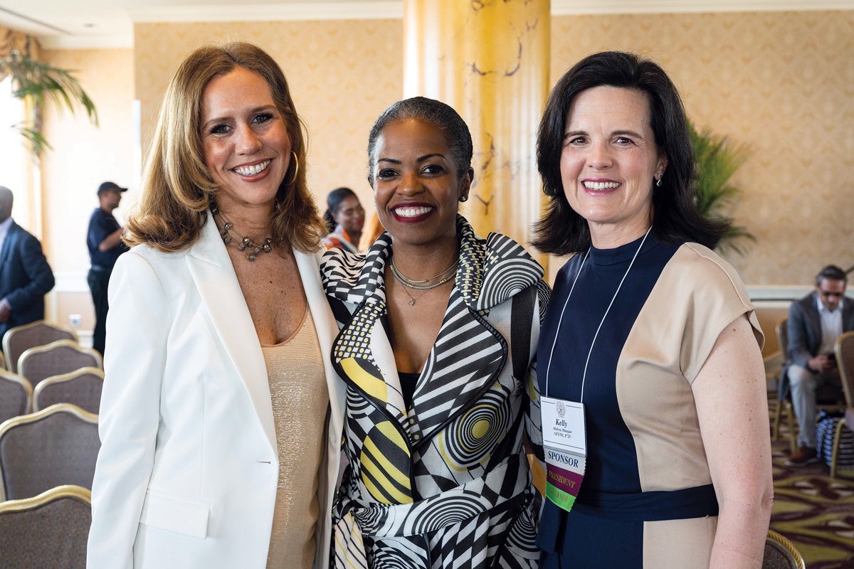 GUAA Executive Director Julia Farr shares a laugh with Mannone Butler (B’94, L’99) and GUAA President Kelly Mulvoy Mangan (SFS’91, Parent’25) at JCW San Francisco in 2023