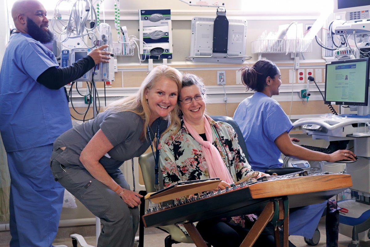 two women smile together in a medical room