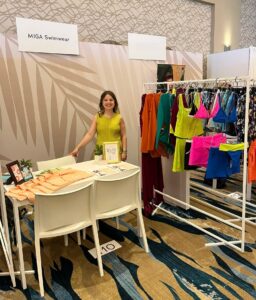 Maria Luisa Mendiola with clothes behind her