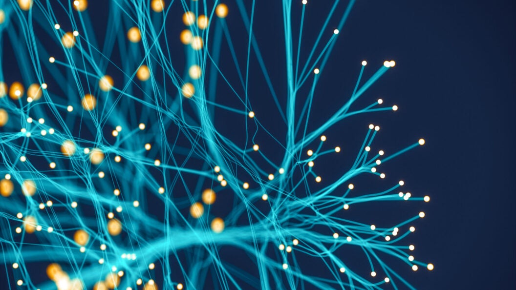 a teal network of electric fibers against a navy background. Photo: iStock
