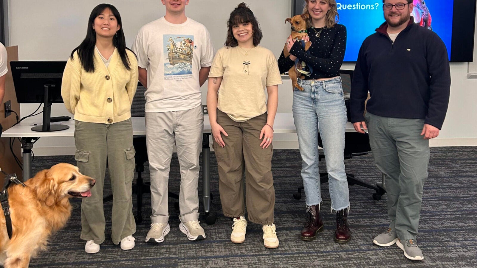 a group of people in a classroom with animals