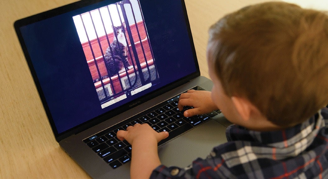 A child playing with macbook pro.