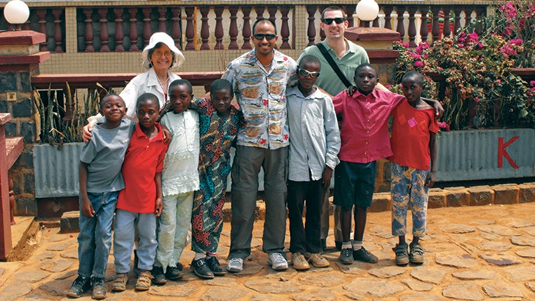Photo of local children with Marilee Cole and two members of the visiting medical team from Georgetown.