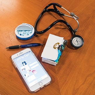 photo of stethoscope, pen, cell phone, and tissues