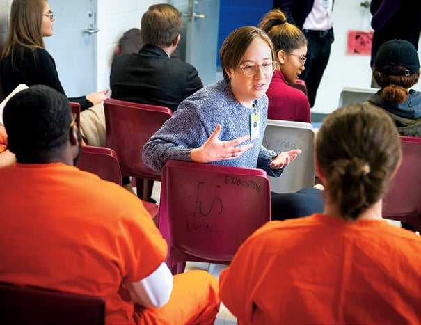 students sitting with prisoners